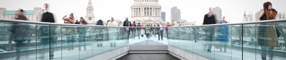 People walking across Millennium Bridge in London